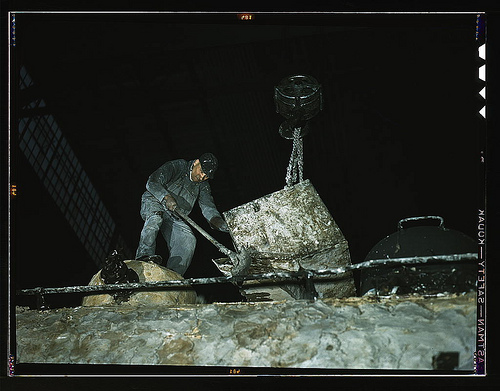 Spreading asbestos mixture on boiler of a locomotive at the C & NW RR 40th Street locomotive shops (LOC)